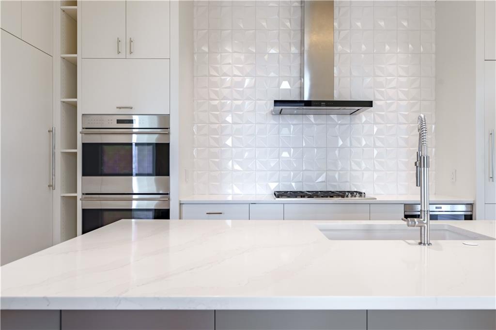 3376 Peachtree Road Northeast, Unit 34A Atlanta, GA 30326 - Photo 7 of 30 a kitchen with a sink and a refrigerator