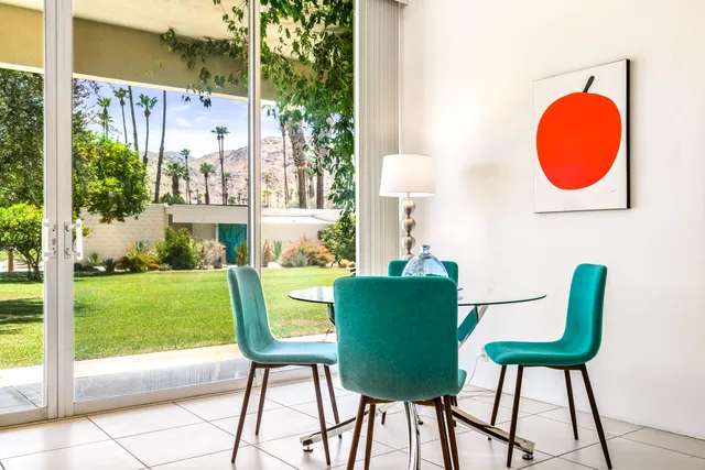 a view of a room with table and chairs