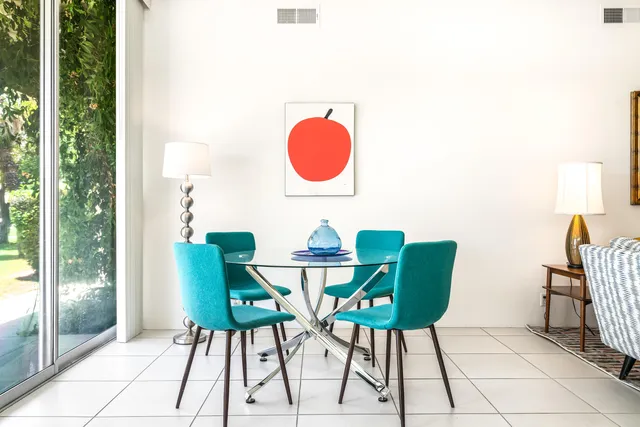 a dining room with furniture and wooden floor