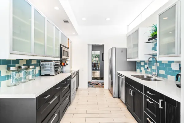 a kitchen with stainless steel appliances and wooden cabinets
