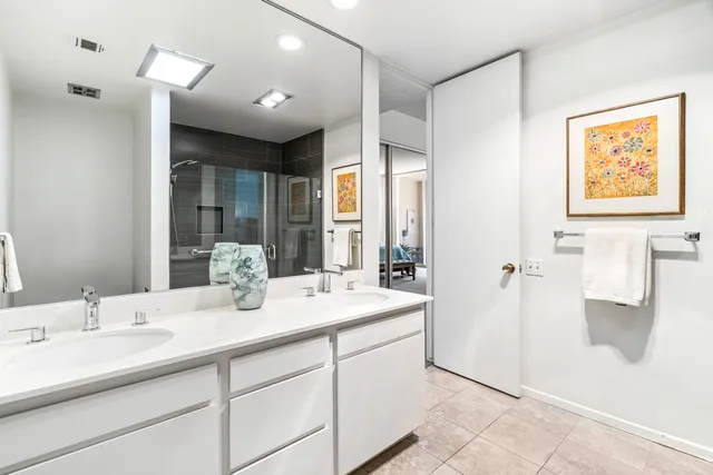 a bedroom with a bed and painting on the wall