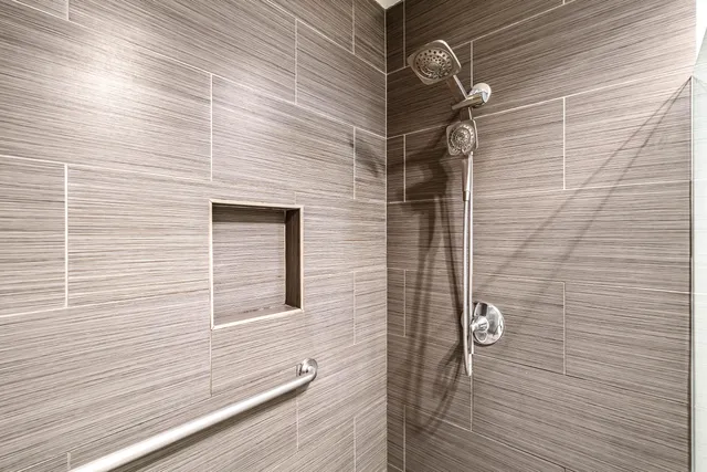 a view of a bedroom with a bed and a window