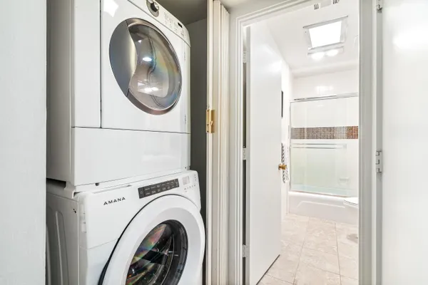 a view of a house with a big yard and large tree