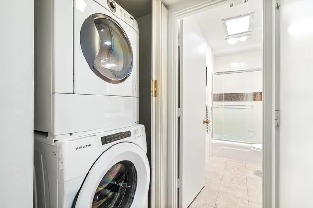 a view of a house with a big yard and large tree