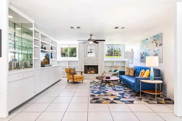a kitchen with stainless steel appliances kitchen island granite countertop a sink and a wooden floors