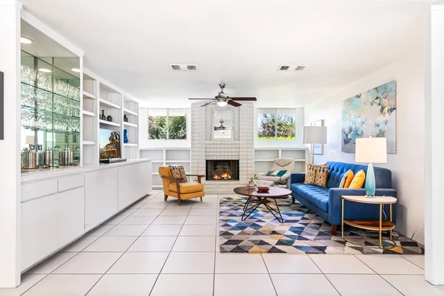 a kitchen with stainless steel appliances kitchen island granite countertop a sink and a wooden floors