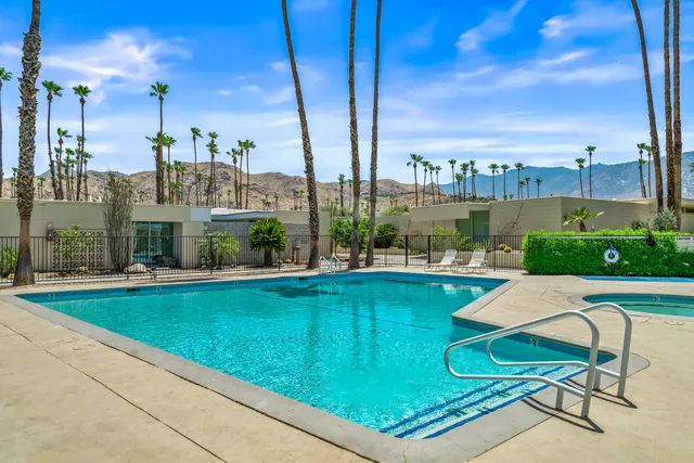 a living room with furniture a flat screen tv and a large window
