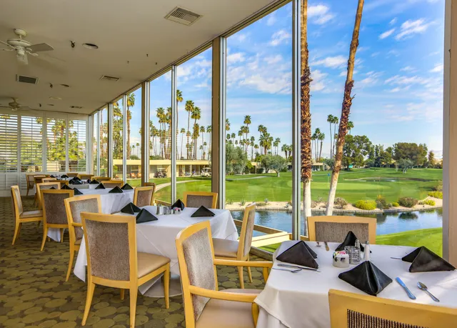 a view of a golf course with a house in the background