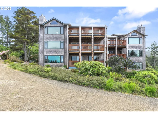 a front view of a residential apartment building with a yard