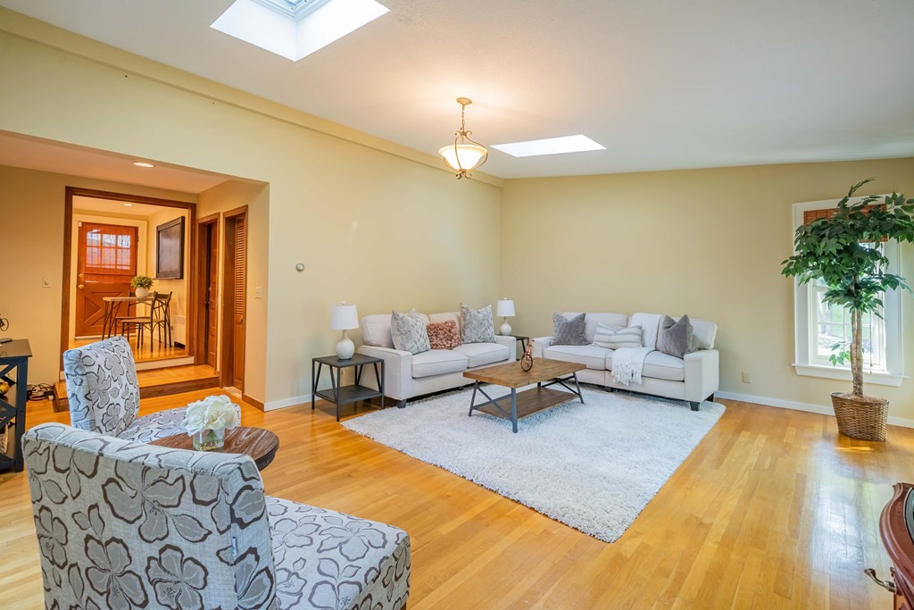 97 Blake Road Lexington, MA 02420 - Photo 23 of 42 a living room with furniture and a chandelier