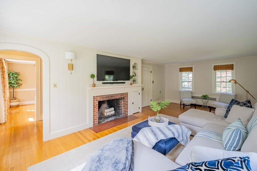 97 Blake Road Lexington, MA 02420 - Photo 3 of 42 a living room with furniture a fireplace and a flat screen tv