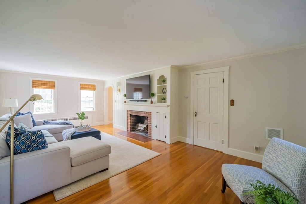 97 Blake Road Lexington, MA 02420 - Photo 6 of 42 a living room with furniture a fireplace and a table