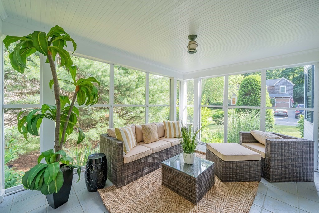 97 Blake Road Lexington, MA 02420 - Photo 8 of 42 a living room with patio furniture and a garden