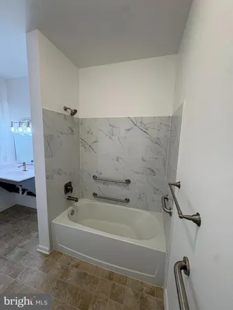 a bathroom with a bathtub and toilet