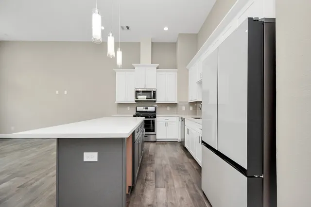 a kitchen with white cabinets and white appliances