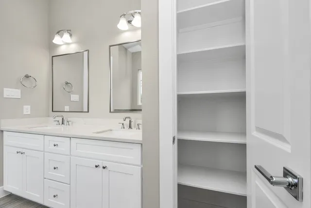 a bathroom with a sink vanity and mirror