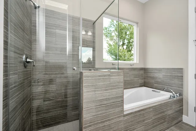 a bathroom with a bathtub and shower