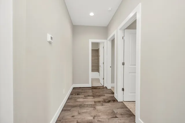 a view of a hallway with wooden floor