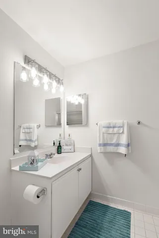 a bathroom with a sink vanity and mirror