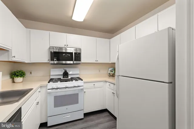 a white refrigerator freezer sitting in a kitchen