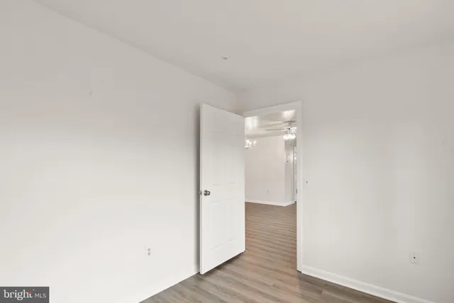 a view of a room with wooden floor
