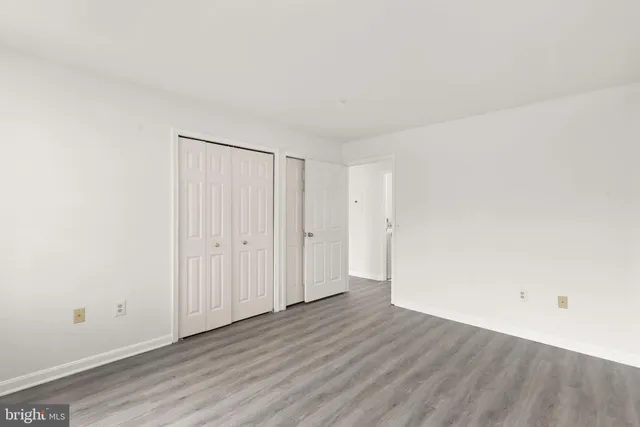 a view of an empty room and wooden floor