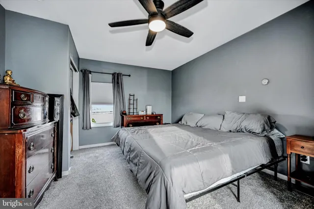 a spacious bedroom with a bed and a chandelier