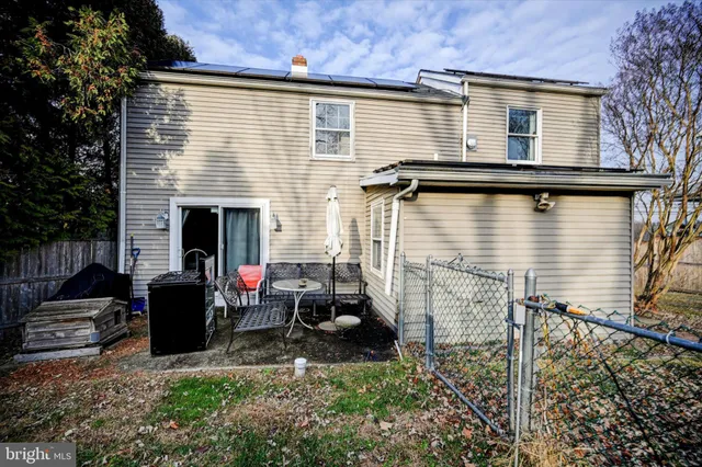 a view of a patio with couches chairs potted plants and a palm tree