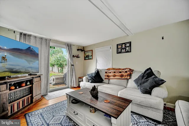 a living room with furniture and a book shelf