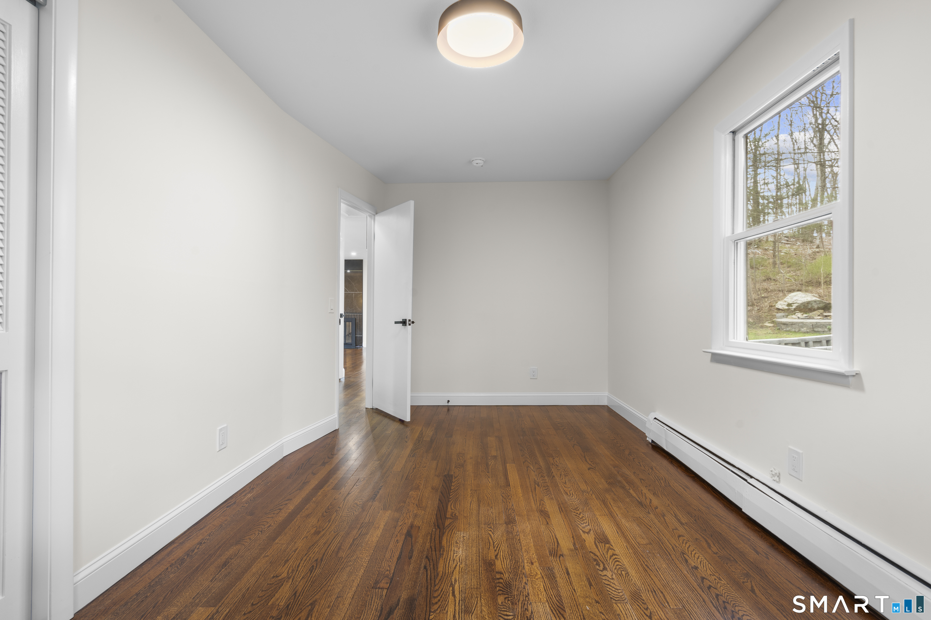 70 Dayton Road Redding, CT 06896 - Photo 13 of 38 an empty room with wooden floor and windows