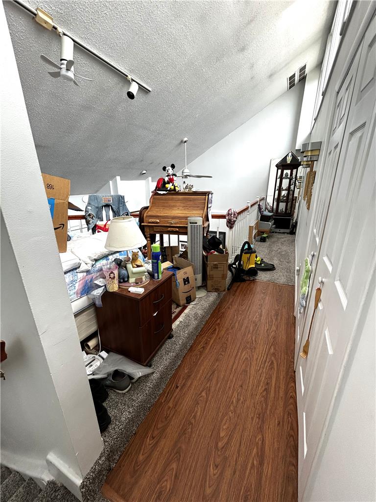 1214 Stanford Road Bethlehem, PA 18018 - Photo 37 of 58 An airy loft area features sloped ceilings and a blend of carpet and wood flooring.