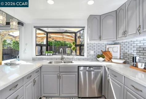 a kitchen with appliances a refrigerator and cabinets