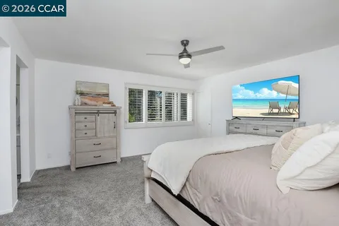 a bedroom with a bed and a dresser