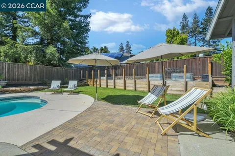a view of patio with a chairs and table in the patio
