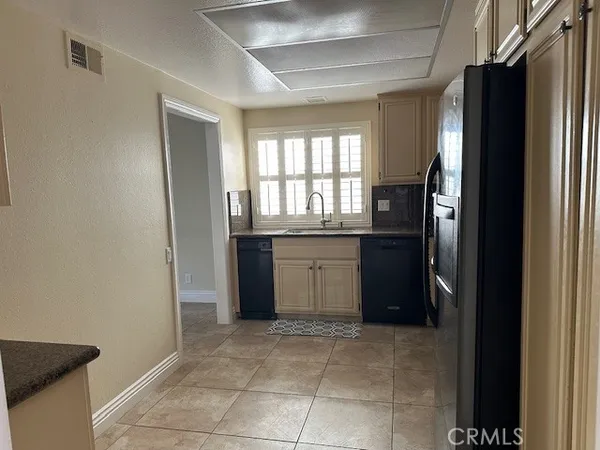 a kitchen with a refrigerator and a sink