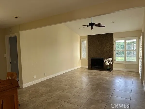 a view of a livingroom with a fireplace and a window