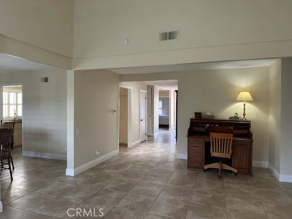 a view of a hallway with wooden floor and furniture