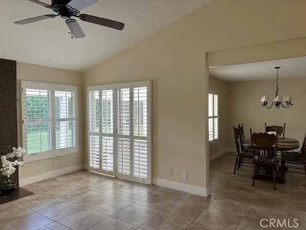 a view of a dining room with furniture and chandelier