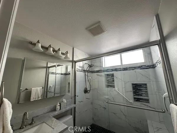 a bathroom with a mirror and a shower