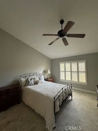 a bedroom with a bed and ceiling fan