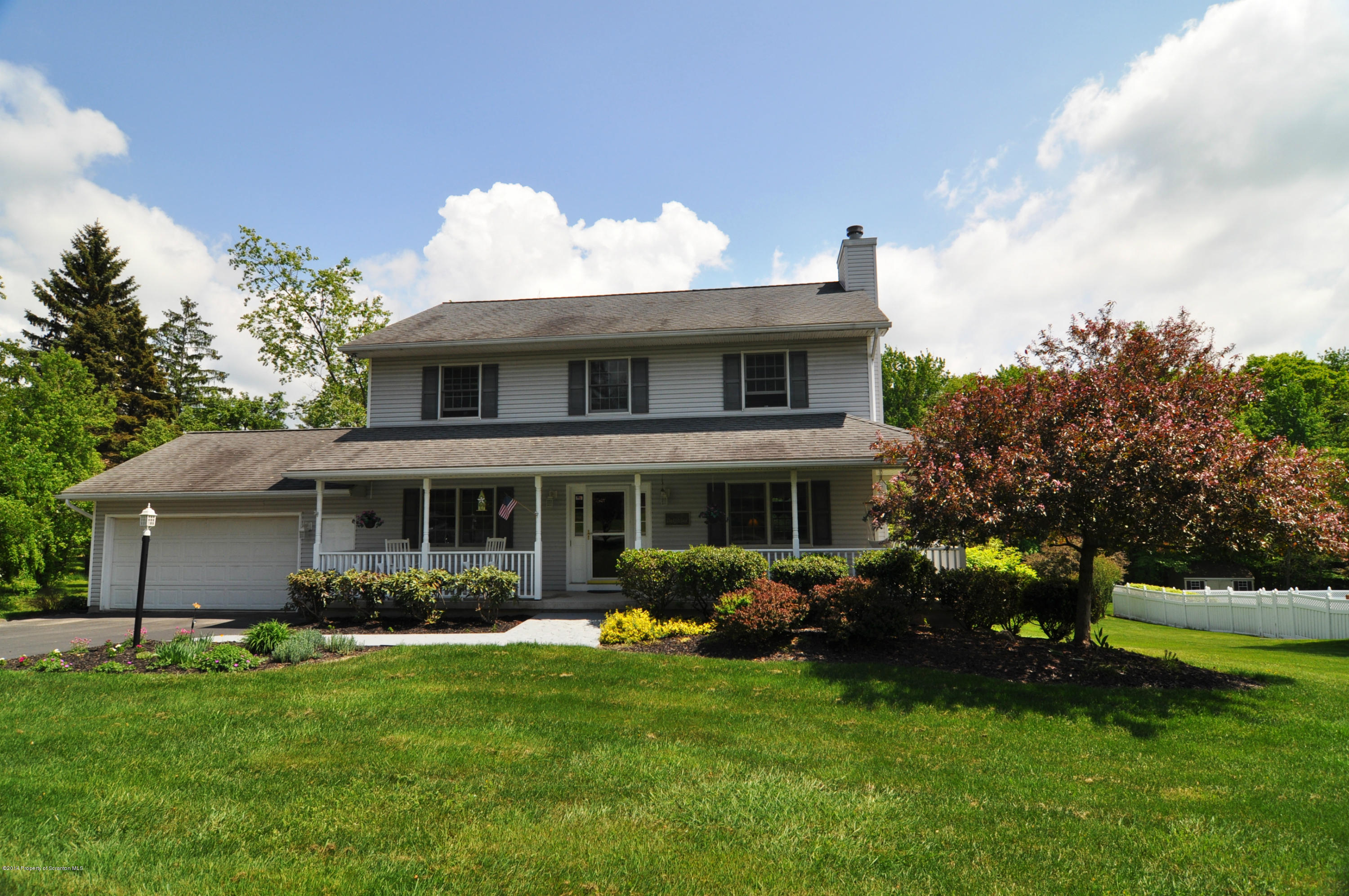 116 Griffin Road Moscow, PA 18444 - Photo 1 of 50 a front view of a house with garden and plants