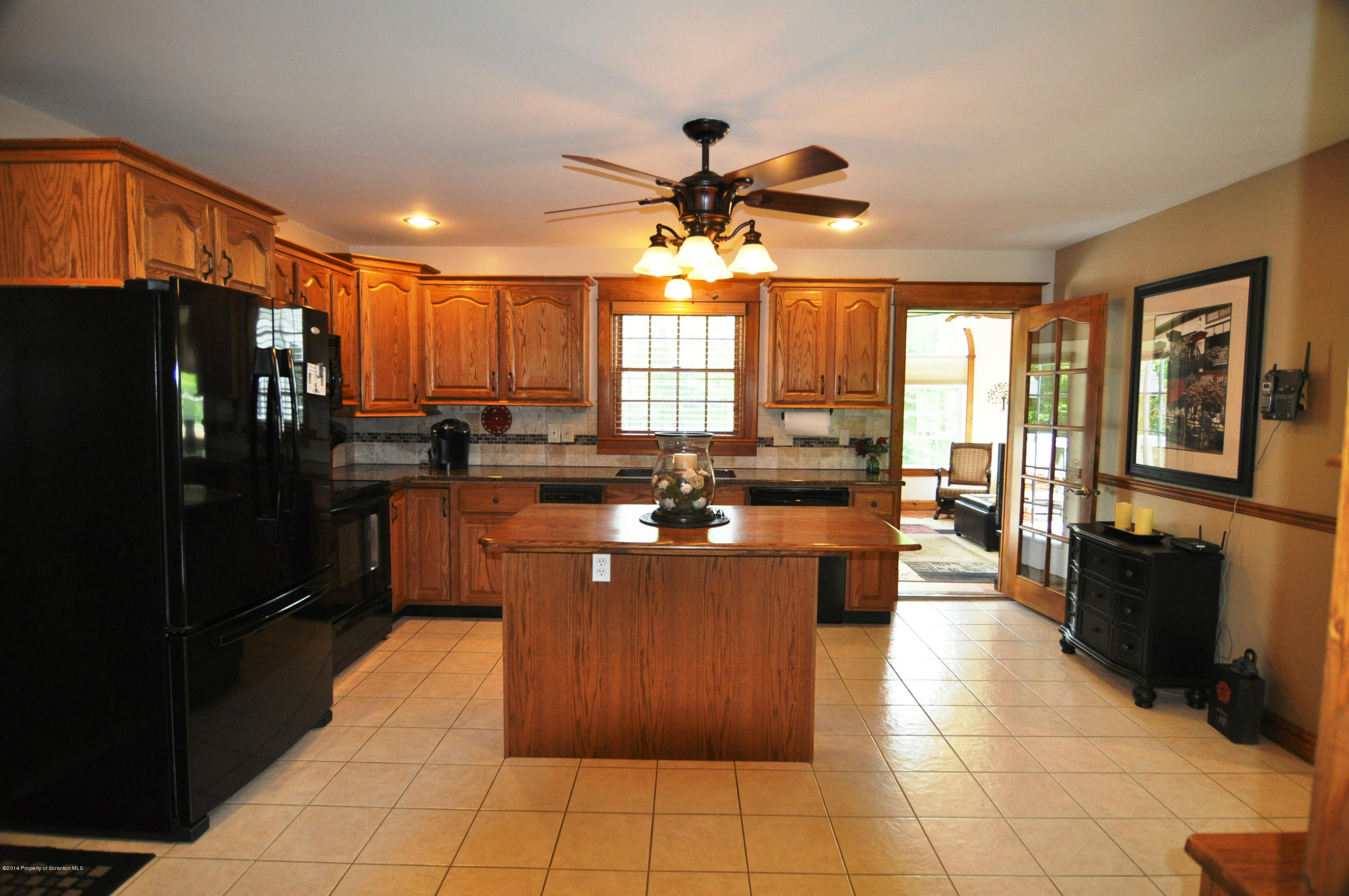 116 Griffin Road Moscow, PA 18444 - Photo 11 of 50 a large kitchen with kitchen island granite countertop a large counter top stainless steel appliances a window and a counter top space