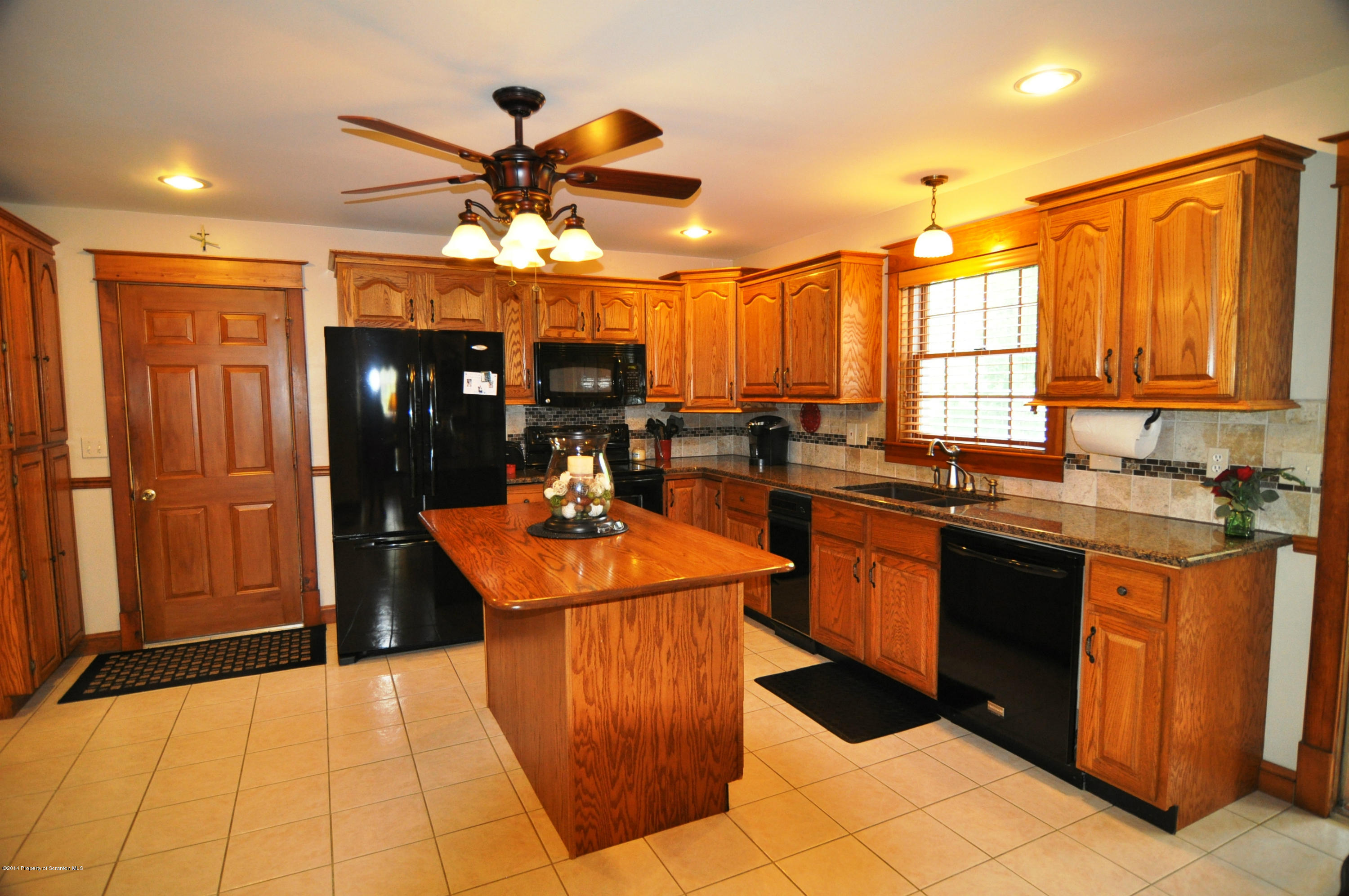116 Griffin Road Moscow, PA 18444 - Photo 12 of 50 a kitchen with stainless steel appliances granite countertop a sink and a refrigerator