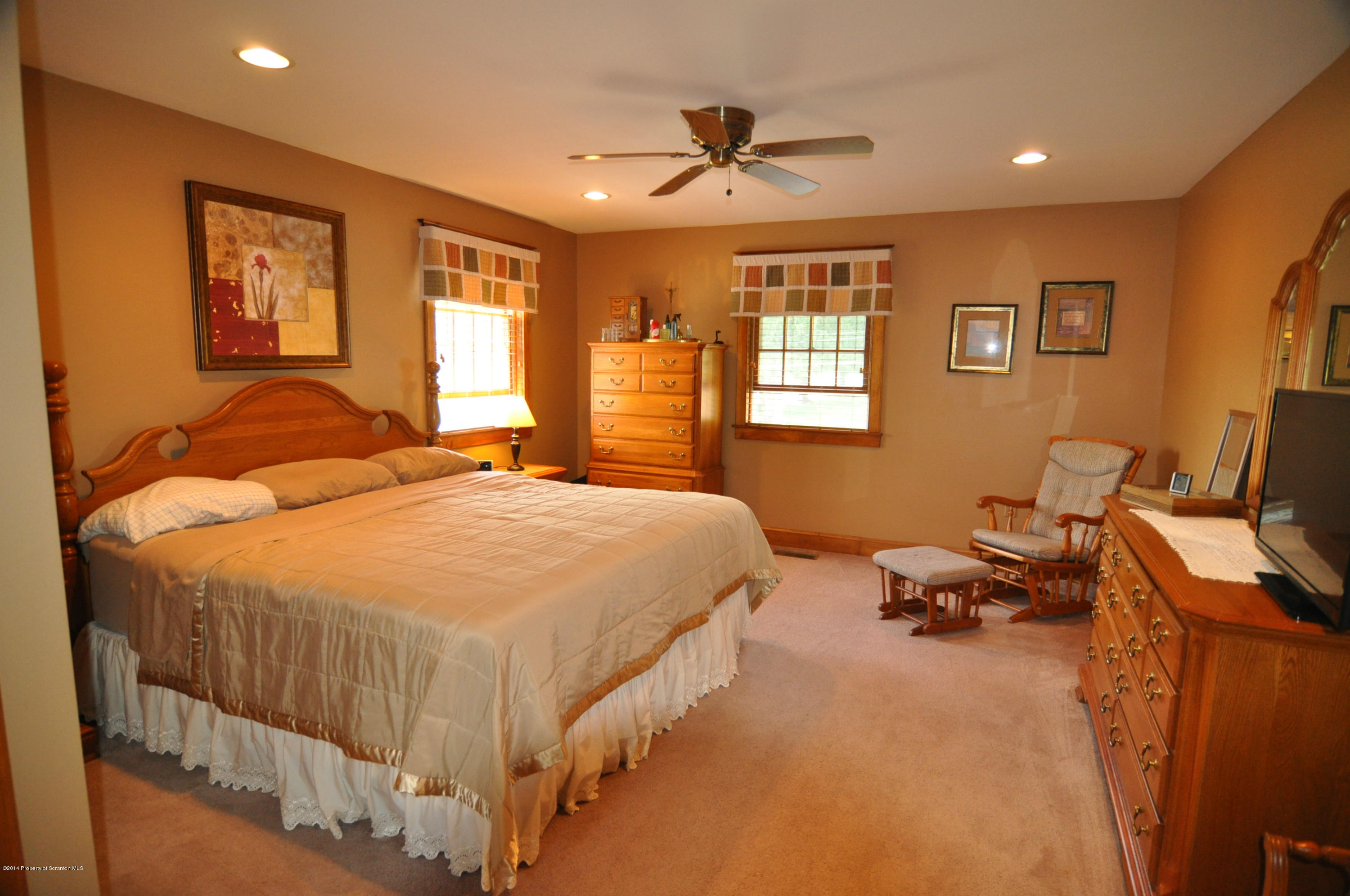116 Griffin Road Moscow, PA 18444 - Photo 23 of 50 a spacious bedroom with a bed and wooden floor