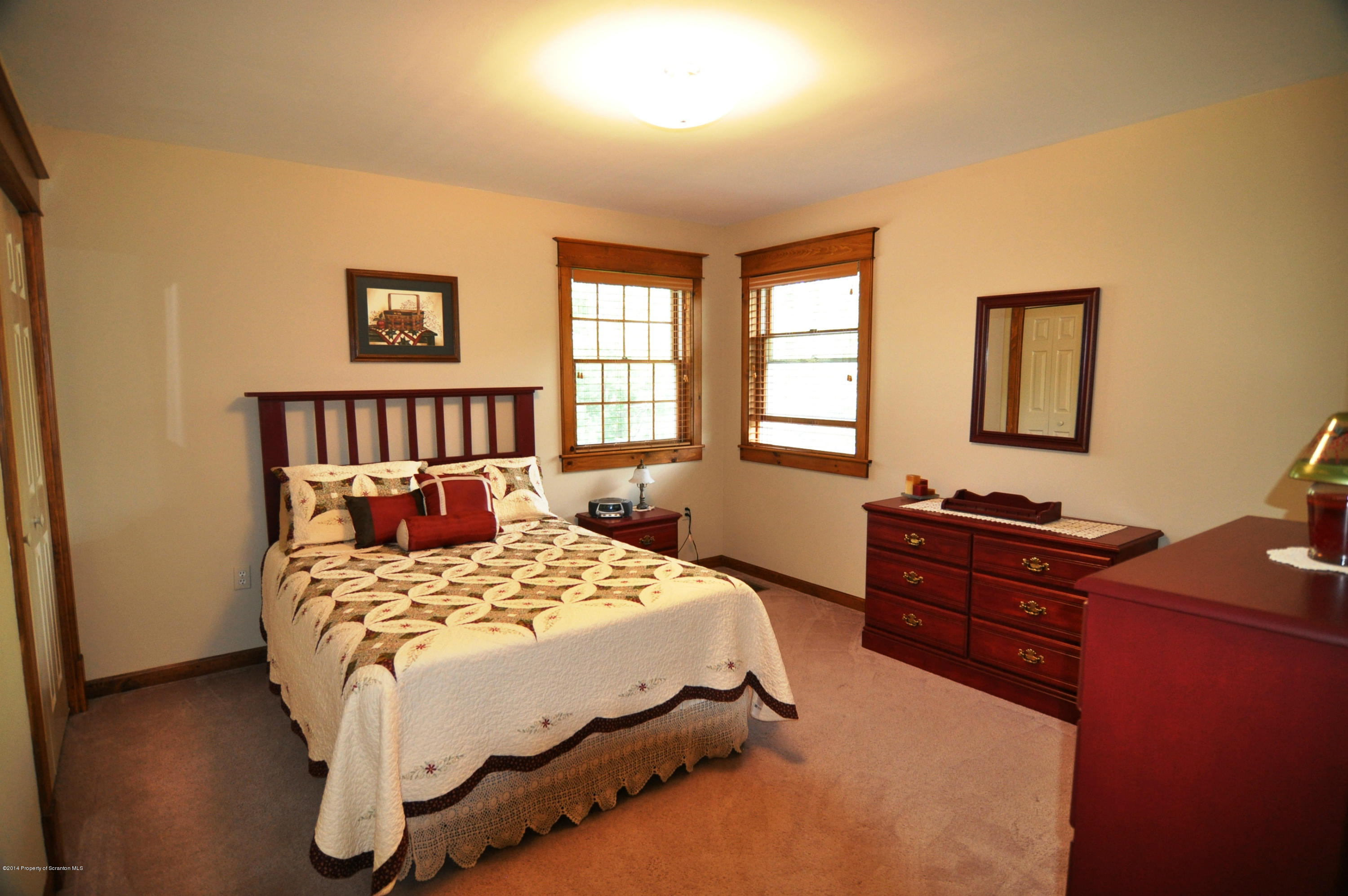 116 Griffin Road Moscow, PA 18444 - Photo 26 of 50 a bedroom with a bed and wooden floor