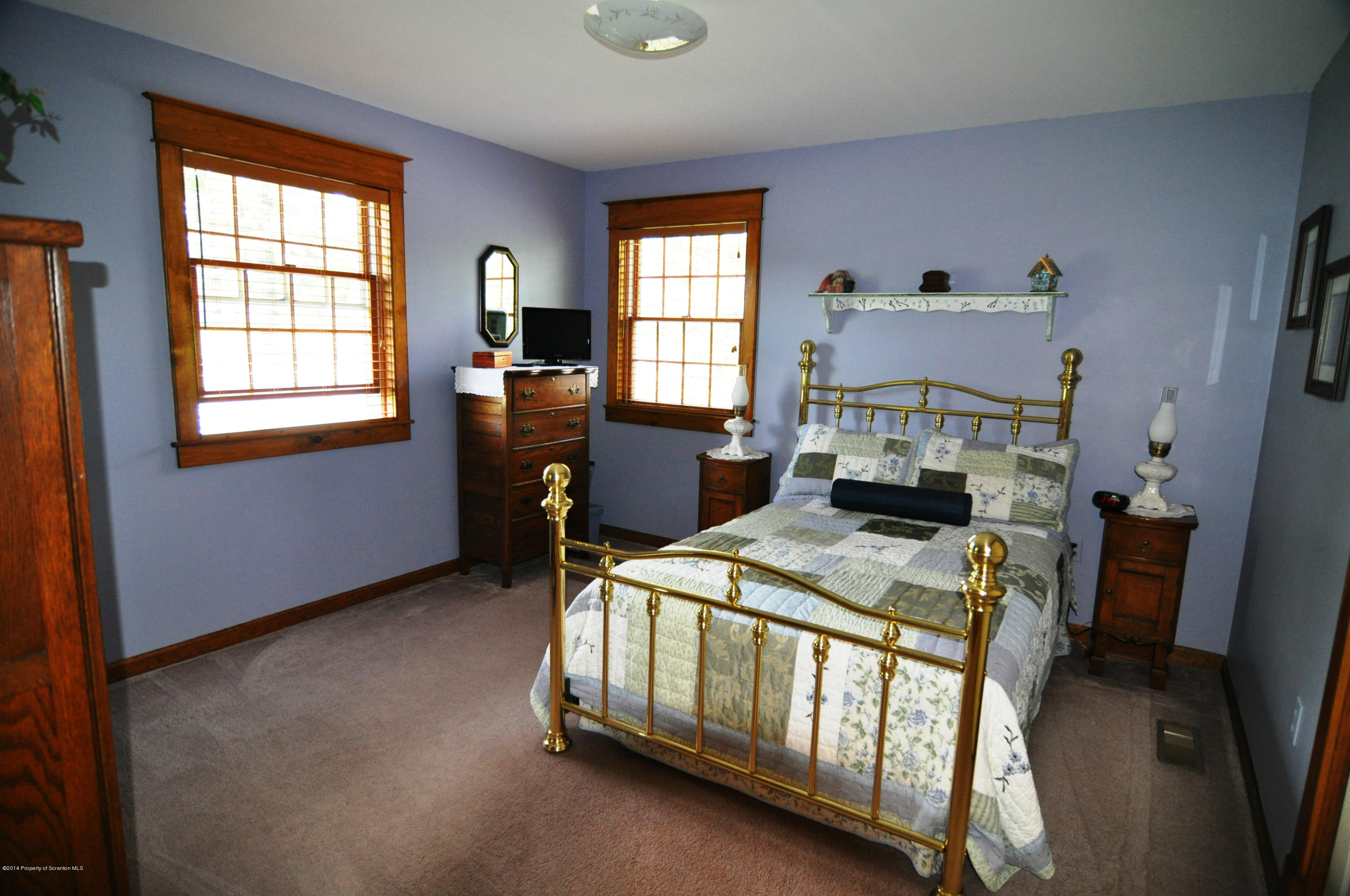 116 Griffin Road Moscow, PA 18444 - Photo 27 of 50 a bedroom with a bed a table and windows