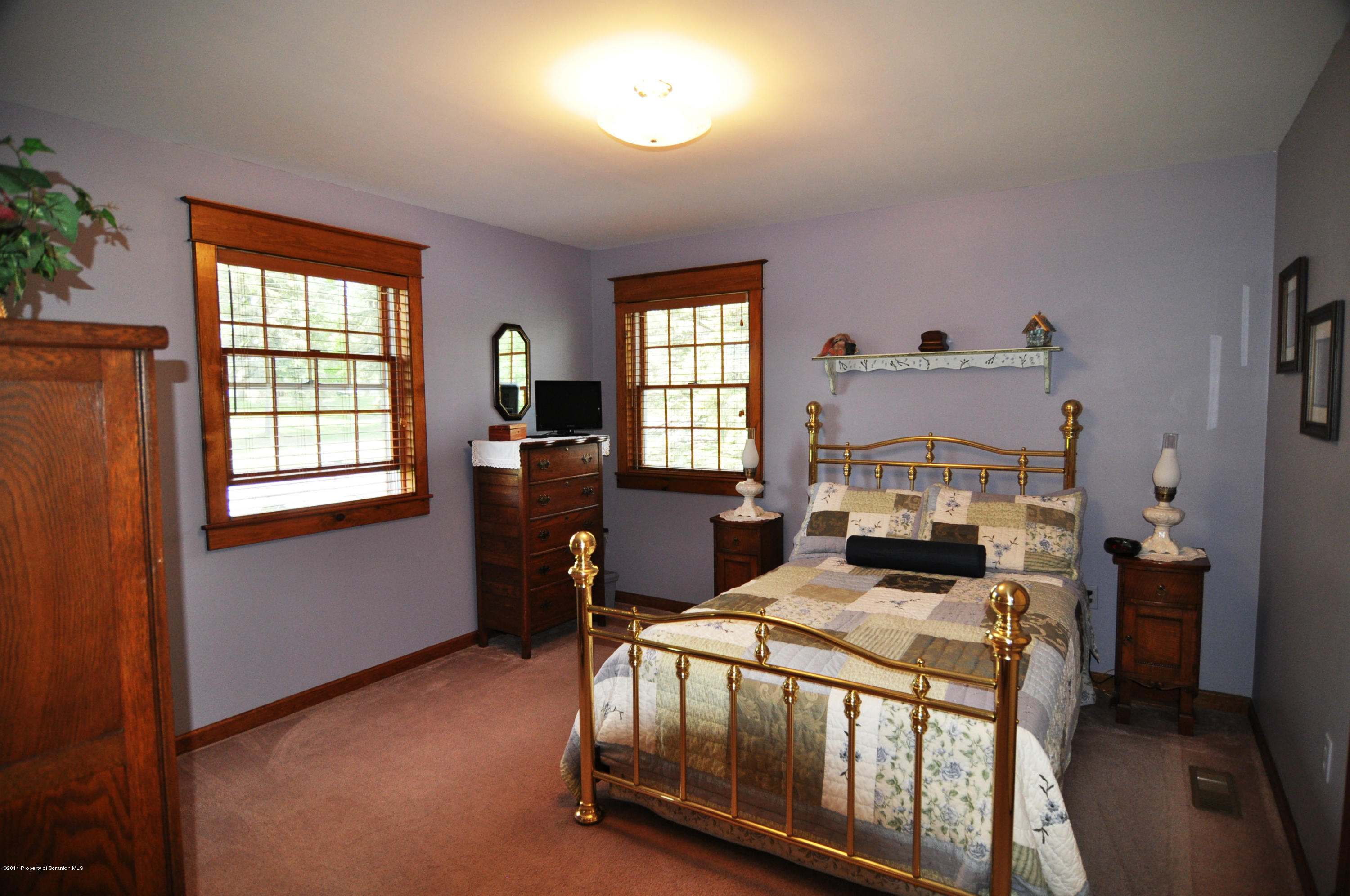 116 Griffin Road Moscow, PA 18444 - Photo 28 of 50 a bedroom with a bed chair and a window