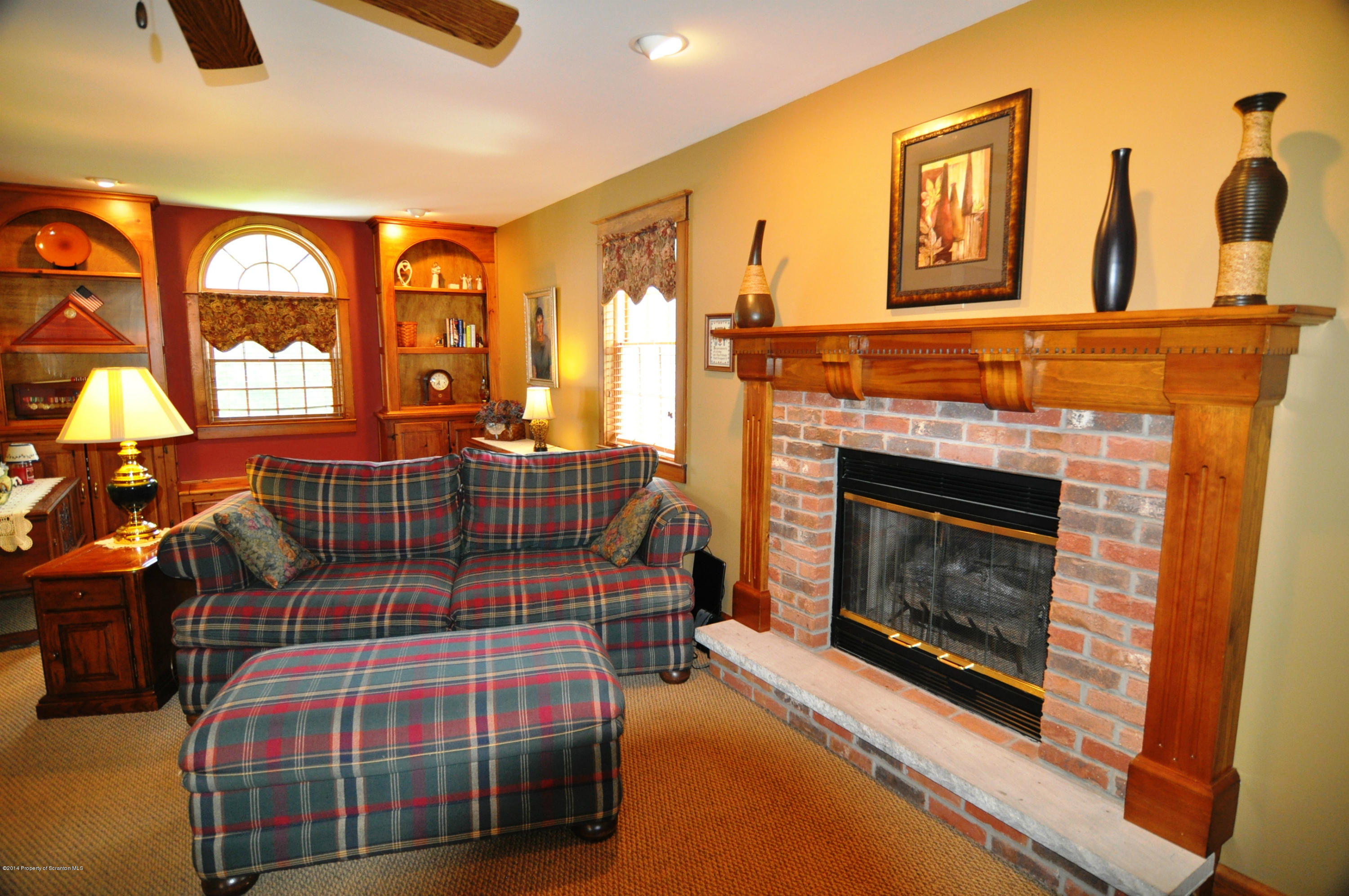 116 Griffin Road Moscow, PA 18444 - Photo 3 of 50 a bedroom with furniture and a fireplace