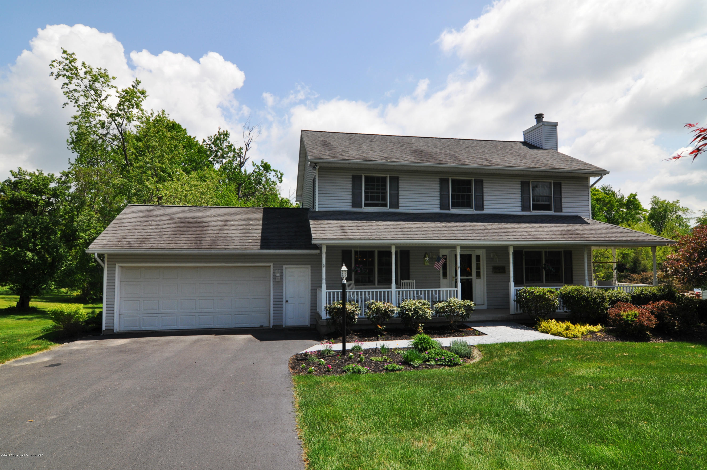 116 Griffin Road Moscow, PA 18444 - Photo 32 of 50 a front view of a house with a yard and potted plants