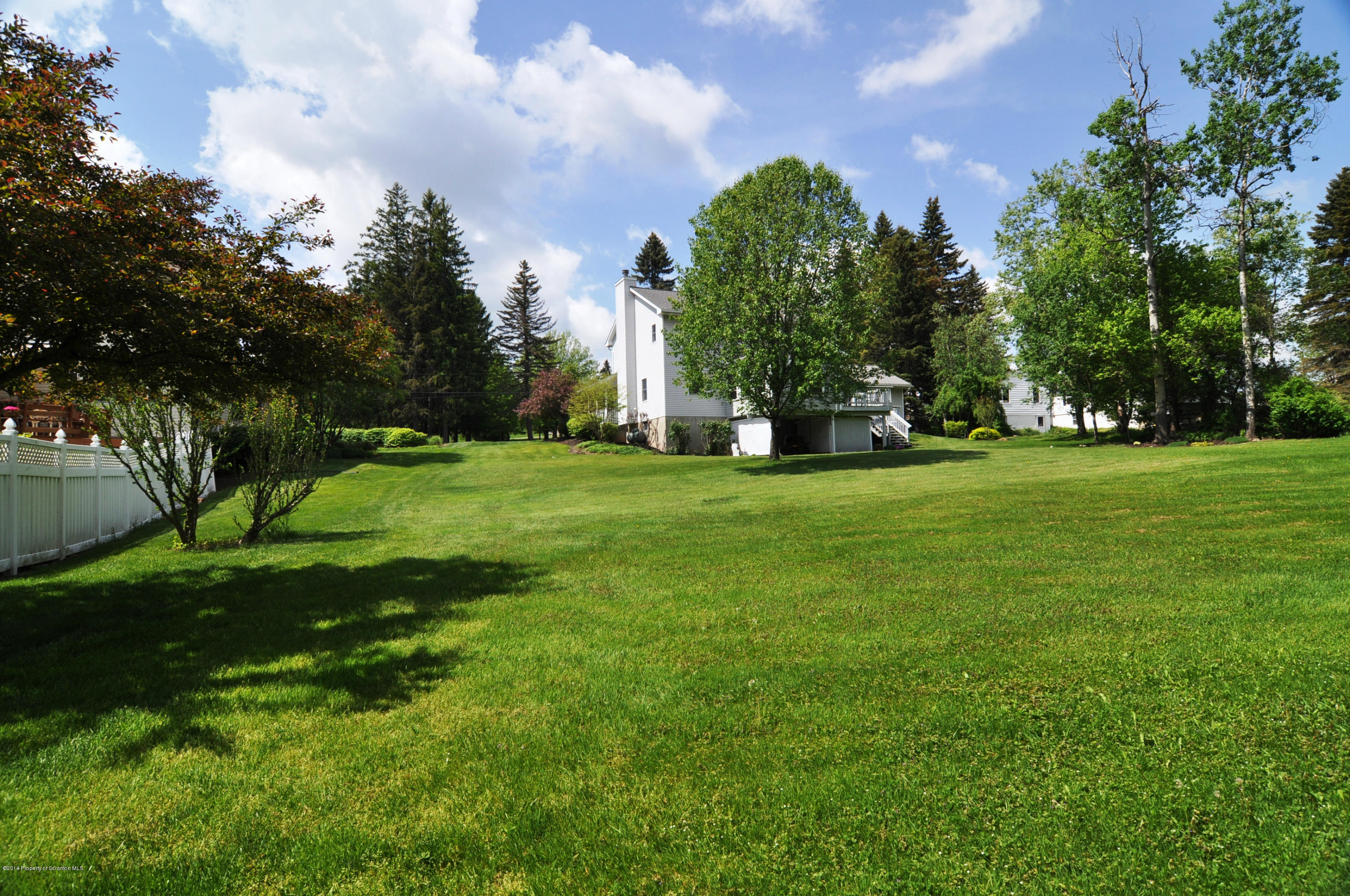 116 Griffin Road Moscow, PA 18444 - Photo 48 of 50 a view of a grassy field with trees around